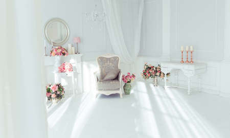 luxury clean bright white interior. a spacious room with sunlight and flowers in vasesの写真素材