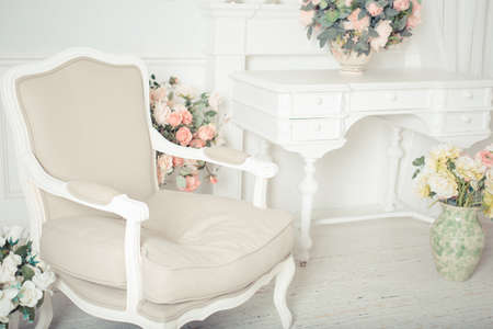 luxury clean bright white interior. a spacious room with sunlight and flowers in vasesの写真素材