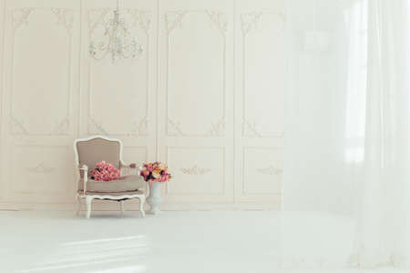 luxury clean bright white interior. a spacious room with sunlight and flowers in vasesの写真素材