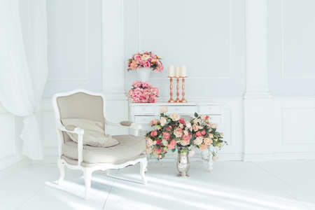 luxury clean bright white interior. a spacious room with sunlight and flowers in vasesの写真素材