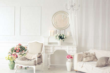 luxury clean bright white interior. a spacious room with sunlight and flowers in vasesの写真素材