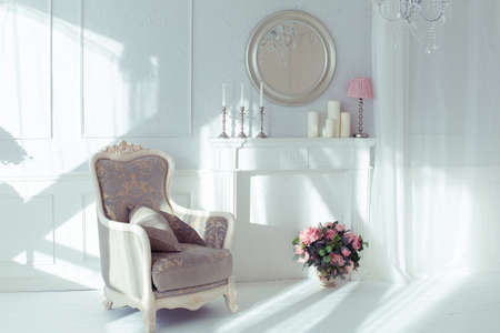 luxury clean bright white interior. a spacious room with sunlight and flowers in vasesの写真素材