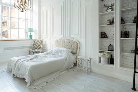 Stylish luxury white bedroom interior design in soft day light with elegant classic furniture