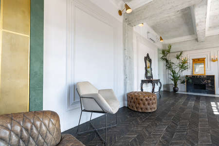 Chic, luxurious guest room design with old-fashioned antique furniture. white walls are decorated...