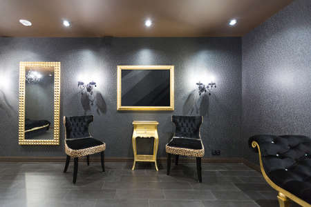 luxurious romantic room in a pompous style in black and gold colors with magnificent furnitureの写真素材