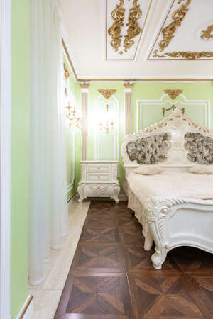 small luxury bedroom with bath and expensive furniture in a chic old baroque style.