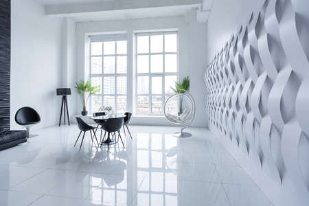 Luxurious futuristic trendy modern interior in contrasting black and white colors with interesting fashionable black furniture and decorated wallの写真素材