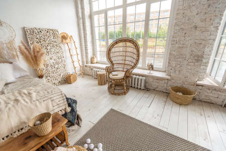 Large spacious room with a trendy loft design of sitting area. huge windows and stylish wicker light...