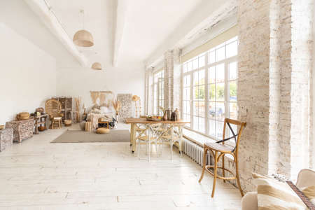 Large spacious room with a trendy loft design of sitting area. huge windows and stylish wicker light...