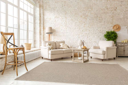 Large spacious room with a trendy loft design of sitting area. huge windows and stylish wicker light...
