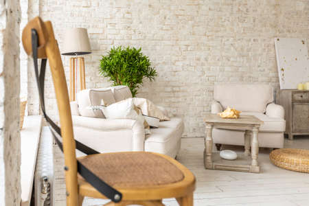 Large spacious room with a trendy loft design of sitting area. huge windows and stylish wicker light...