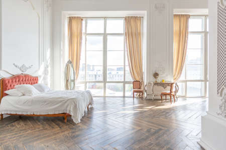 royal baroque style luxury posh interior of large room. extra white, full of day light. high ceiling and walls decorated by stuccoの写真素材