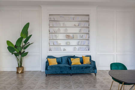 modern and very stylish interior design of large studio apartment with fashionable furniture with gold elements. very light and bright room with big windowsの写真素材