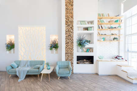 Fashionable spacious apartment with a stylish design in green, gray and white pastel colors with big window and decorative walls. bedroom and kitchen spaceの写真素材