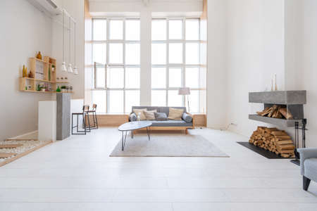 Luxury fashionable modern design studio apartment with a free layout in a minimal style. very bright huge spacious room with white walls and wooden elements.の写真素材