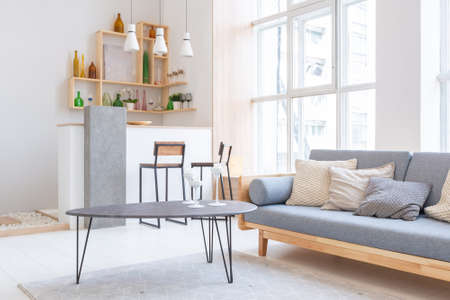 Luxury fashionable modern design studio apartment with a free layout in a minimal style. very bright huge spacious room with white walls and wooden elements.の写真素材