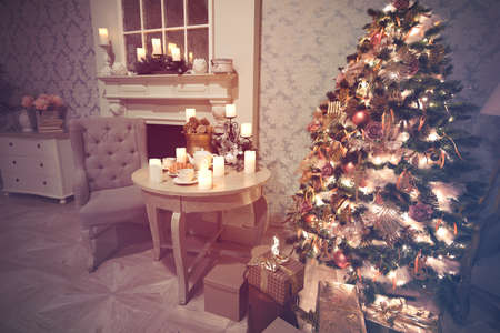 Luxury interior of living room with decorated Christmas tree and gifts on the wooden floorの写真素材