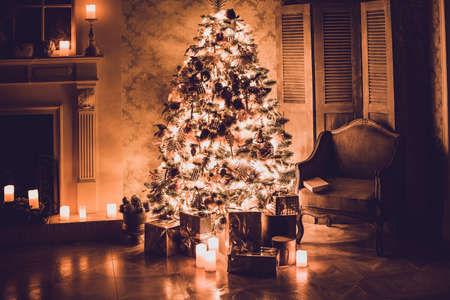 Luxury interior of living room with decorated Christmas tree and gifts on the wooden floorの写真素材