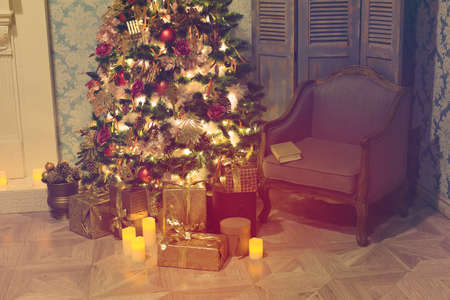 Luxury interior of living room with decorated Christmas tree and gifts on the wooden floorの写真素材