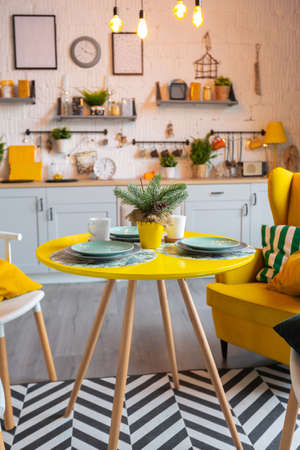 Trendy fashion luxury interior design in Scandinavian style of studio apartment with bright yellow furniture and decorated with new year lights.の写真素材