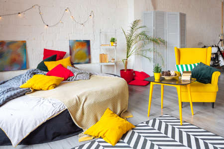 Trendy fashion luxury interior design in Scandinavian style of studio apartment with bright yellow...