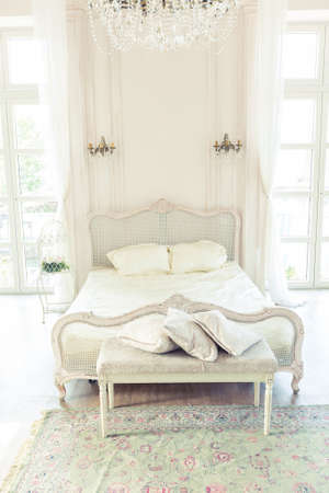 beautiful white bright clean interior bedroom in luxurious baroque style.の写真素材