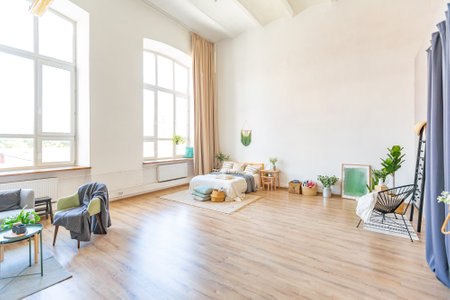 interior of stylish loft. spacious apartment with large windows, parquet on the floor and light walls. closeup view of shelving with different small things for decorationの写真素材