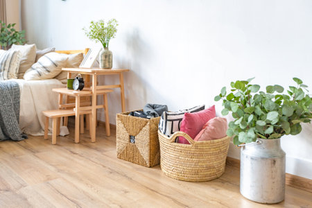 interior of stylish loft. spacious apartment with large windows, parquet on the floor and light walls. closeup view of shelving with different small things for decorationの写真素材