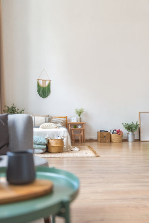 interior of stylish loft. spacious apartment with large windows, parquet on the floor and light walls. closeup view of shelving with different small things for decorationの写真素材