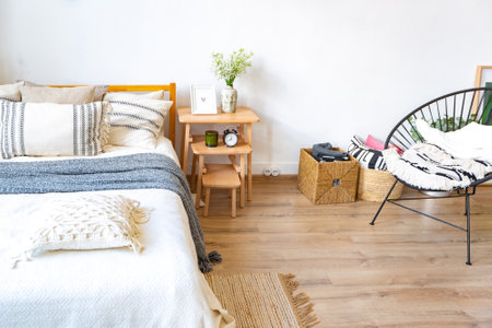 interior of stylish loft. spacious apartment with large windows, parquet on the floor and light walls. closeup view of shelving with different small things for decorationの写真素材