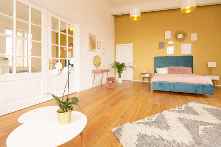 Scandinavian style apartment interior. bright yellow warm colors. wooden flooring. sunlight in large windows.の写真素材