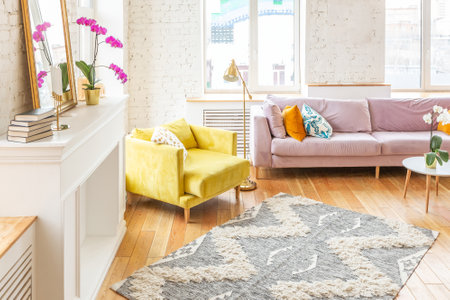 Scandinavian style apartment interior. bright yellow warm colors. wooden flooring. sunlight in large windows.の写真素材