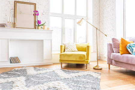 Scandinavian style apartment interior. bright yellow warm colors. wooden flooring. sunlight in large windows.の写真素材