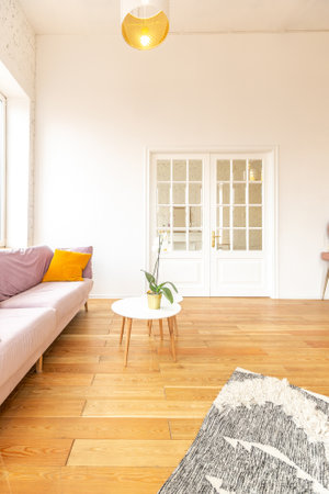 Scandinavian style apartment interior. bright yellow warm colors. wooden flooring. sunlight in large windows.の写真素材