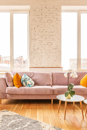 Scandinavian style apartment interior. bright yellow warm colors. wooden flooring. sunlight in large windows.の写真素材