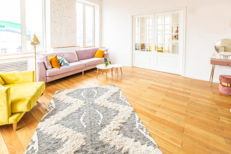 Scandinavian style apartment interior. bright yellow warm colors. wooden flooring. sunlight in large windows.の写真素材