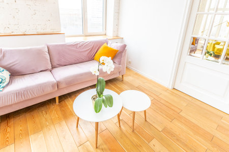Scandinavian style apartment interior. bright yellow warm colors. wooden flooring. sunlight in large windows.の写真素材
