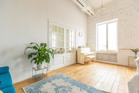 the interior of the study in the style of a loft. Brick wall. wooden flooring. large bright room with a seating area. sofa and pianoの写真素材