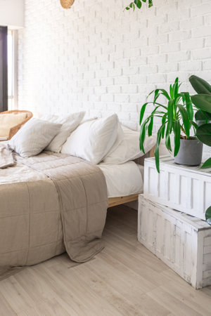 Luxury bedroom design in a rustic cottage in a minimalist style. white walls, panoramic windows, wooden elements of decoration on the ceiling, rope swings in the middle of a spacious room.の写真素材