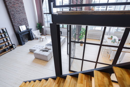 trendy modern design two-level apartment with large high windows. The stylish living room and...