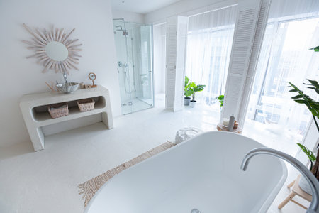 Extra white and very light minimalistic stylish elegant interior of bathroom with modern bath, green...