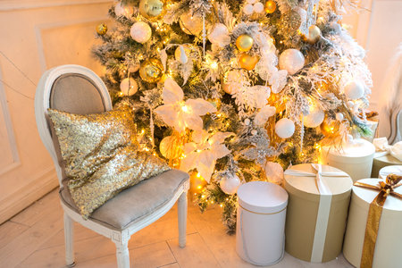 luxurious expensive light interior living room in a royal style decorated with a very beautiful Christmas tree and large windowsの写真素材