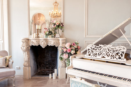 Luxurious light interior of the living room in the baroque style as in a royal castle with old stylish vintage furniture, columns, stucco on the wallsの写真素材