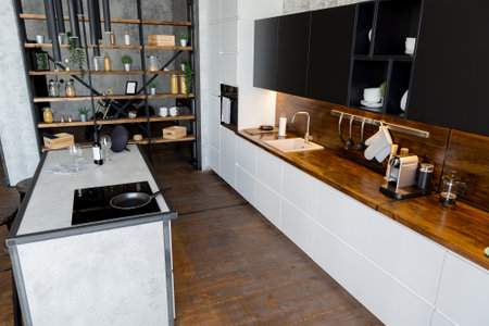 luxury studio apartment with a free layout in a loft style in dark colors. Stylish modern kitchen...