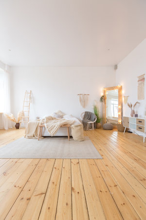 cute cozy light interior design of the apartment with a free layout of the kitchen and bedroom areas. a lot of windows, a wooden floor and a hanging swing.の写真素材