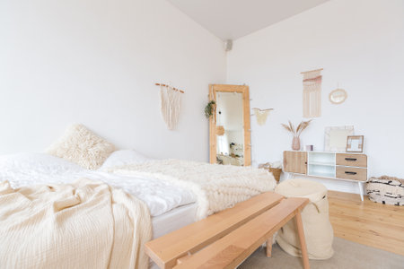 cute cozy light interior design of the apartment with a free layout of the kitchen and bedroom areas. a lot of windows, a wooden floor and a hanging swing.の写真素材