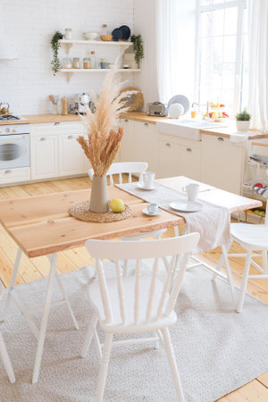 cute cozy light interior design of the apartment with a free layout of the kitchen and bedroom areas. a lot of windows, a wooden floor and a hanging swing.の写真素材