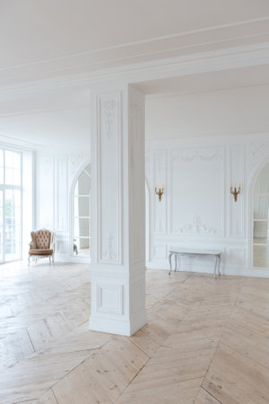 chic white huge spacious hall with a minimum of expensive antique furniture. Baroque interior design...