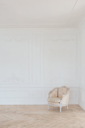 chic white huge spacious hall with a minimum of expensive antique furniture. Baroque interior design with ornament on the walls and parquet on the floor.の写真素材