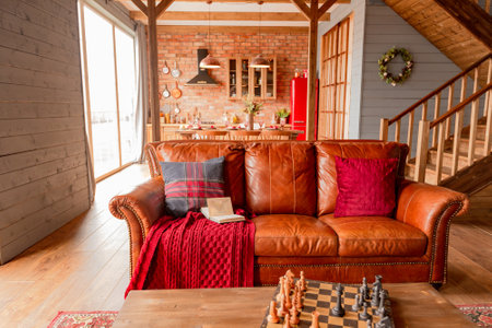 cozy all wooden interior of a country house in a wooden design. spacious living room with kitchen area with large windows. bedroom on the second floor.の写真素材